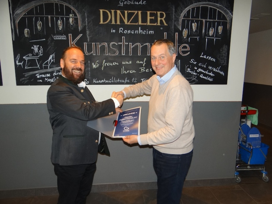 Johann Grander (on left) awards Thomas Steinke, Member of the Board at Dinzler Kaffeeroesterei AG, the document